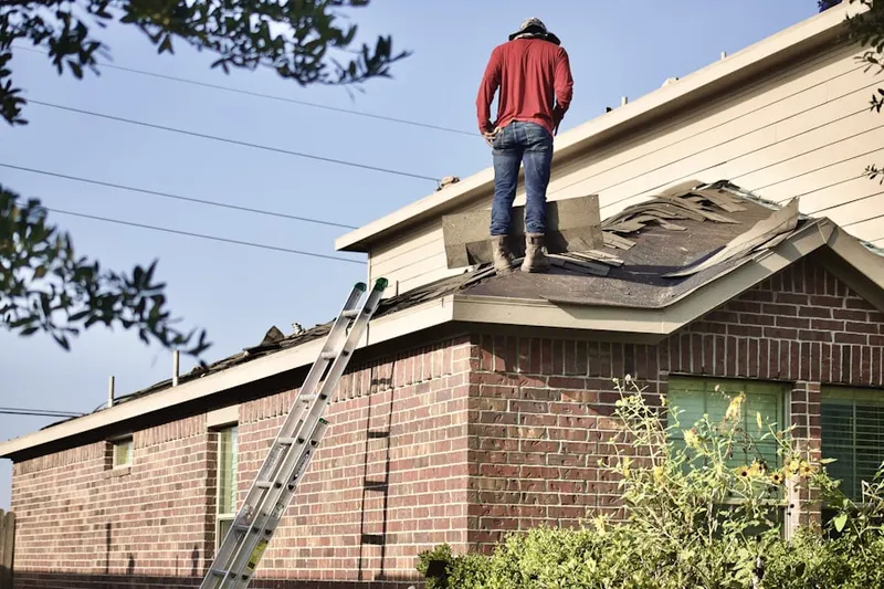 Professional roofer working on a residential roof in Northeast Durham